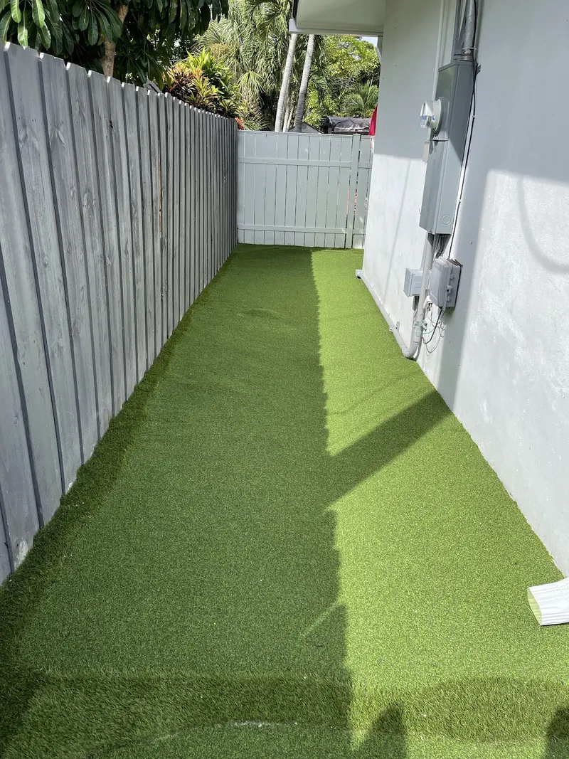 Narrow fenced side yard finished in turf