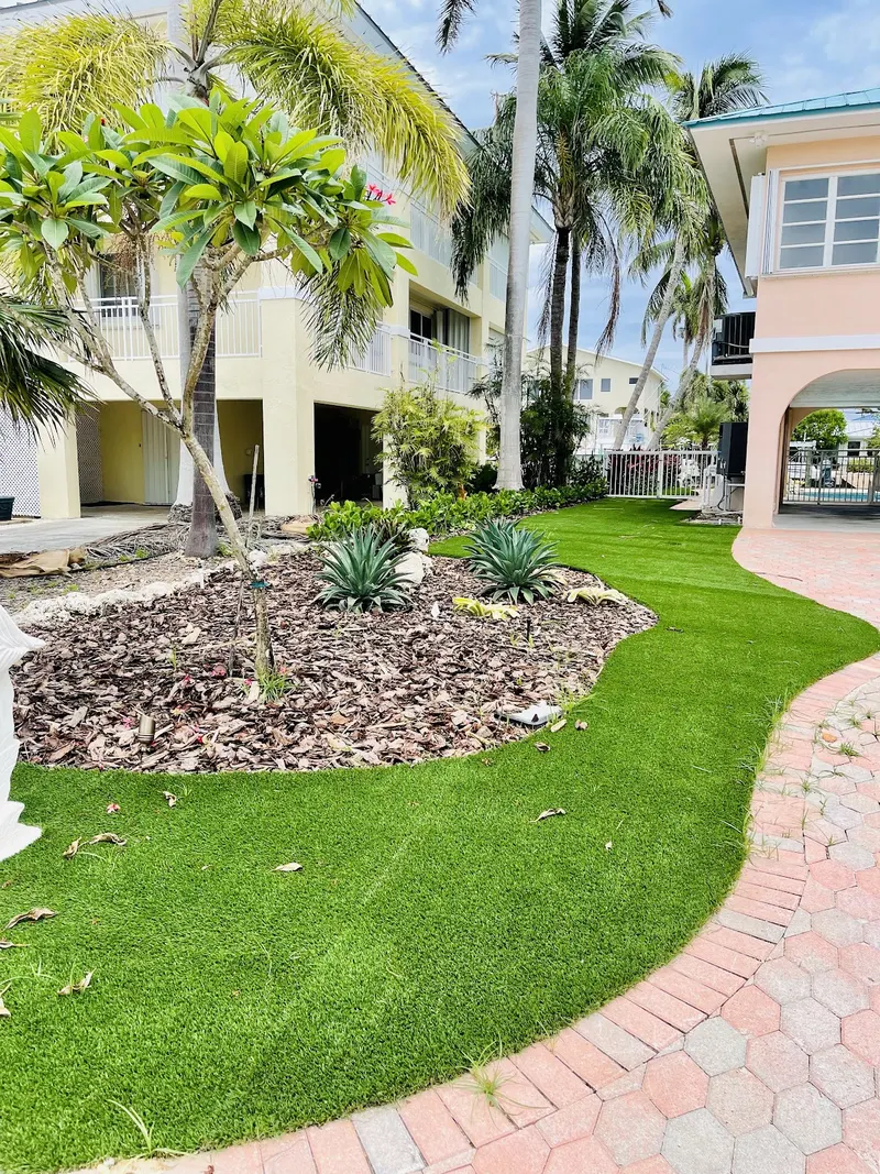 Turf front yard curving along a brick paver path