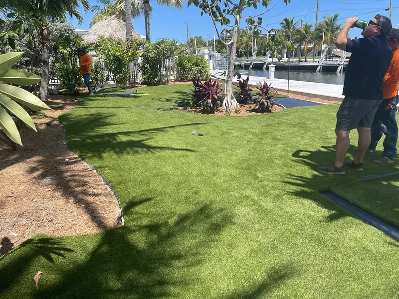 Crew walking a finished backyard turf lawn
